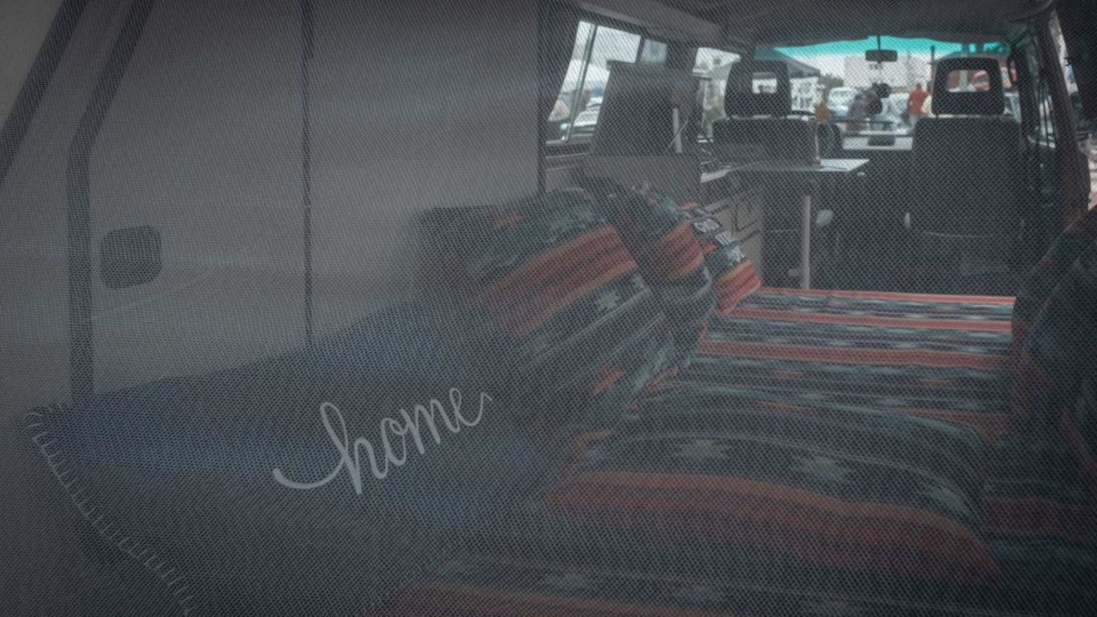 Comfortable bed inside a vintage camper van, perfect for road trips.